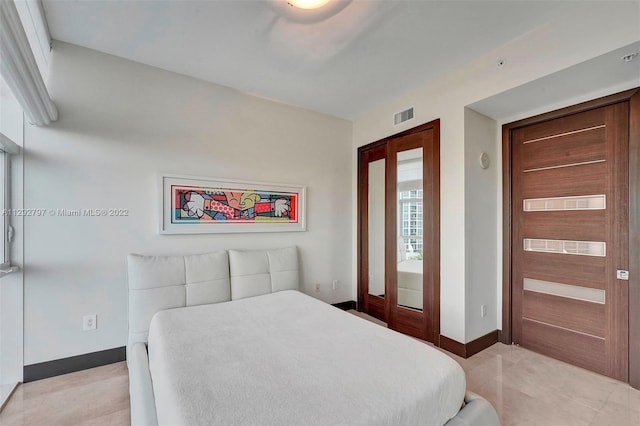 bedroom featuring french doors and light tile floors