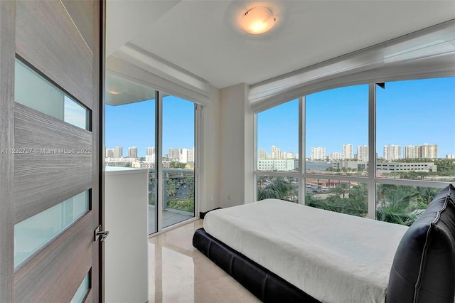 bedroom with light tile floors and expansive windows