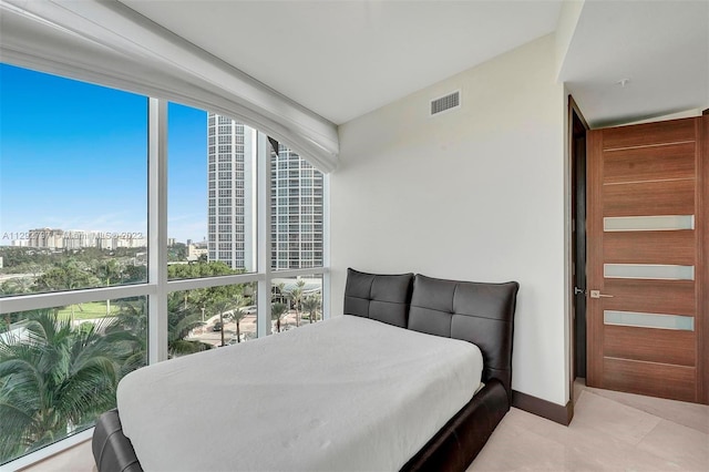 tiled bedroom with expansive windows