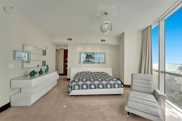 bedroom with floor to ceiling windows and light tile floors