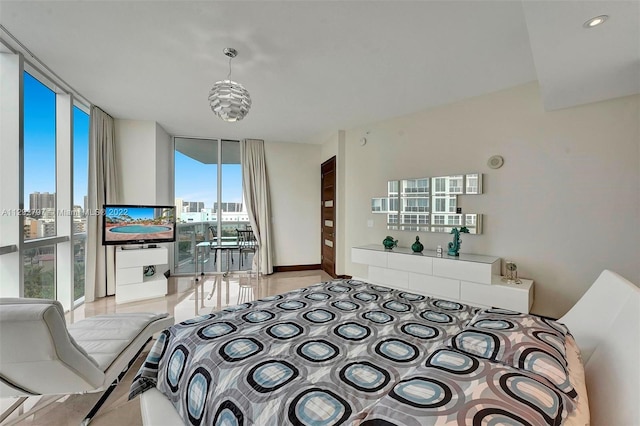 bedroom with a notable chandelier, expansive windows, and multiple windows