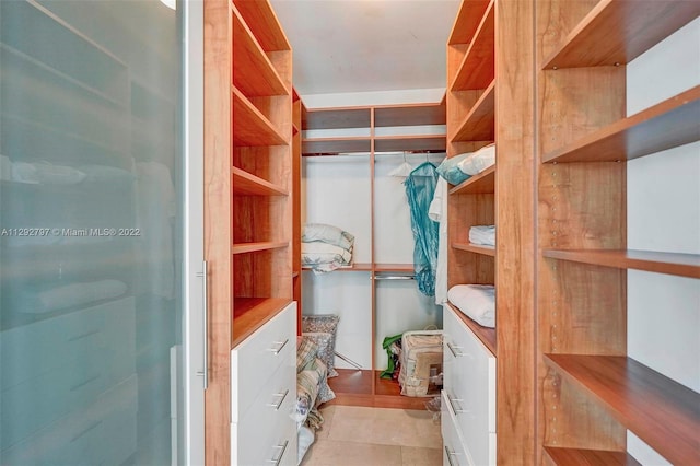 spacious closet featuring light tile floors