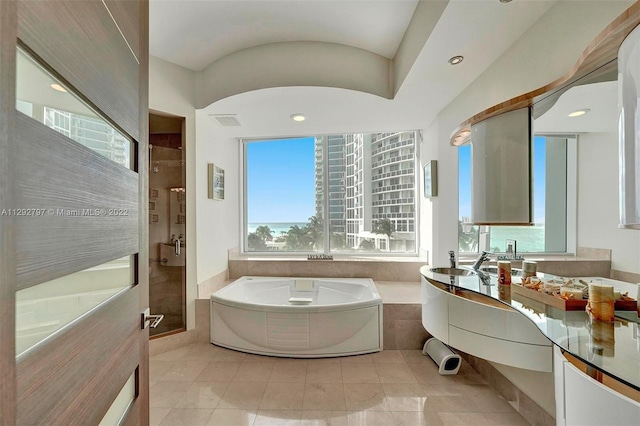 bathroom featuring tile flooring, separate shower and tub, and vanity