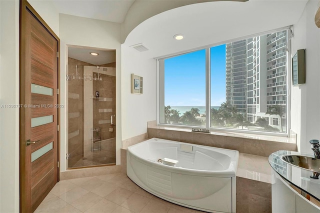 bathroom featuring independent shower and bath and tile flooring