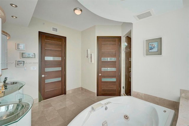 bathroom featuring tile floors, sink, and a bathtub