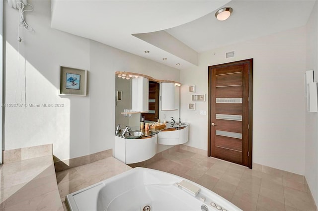 bathroom featuring tile floors and a bathtub