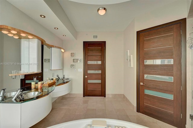 bathroom with double sink vanity, tile flooring, and a washtub