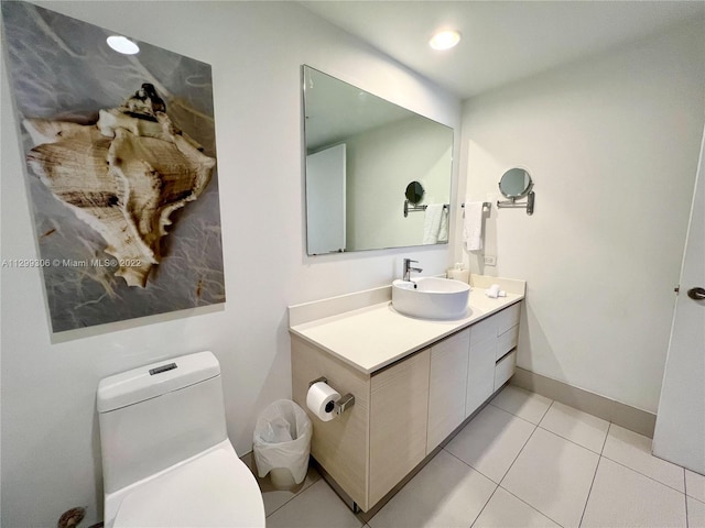 bathroom with toilet, tile flooring, and oversized vanity