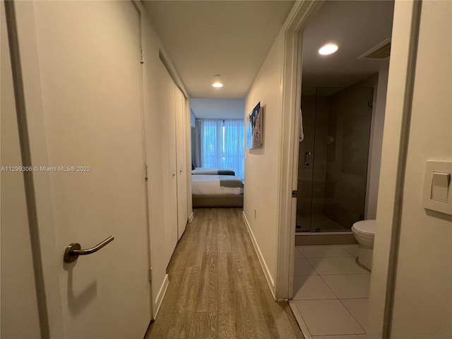 corridor with light hardwood / wood-style flooring