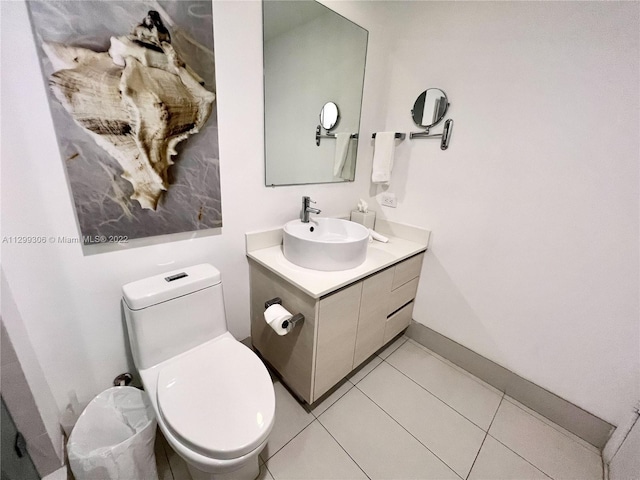 bathroom featuring toilet, tile floors, and vanity