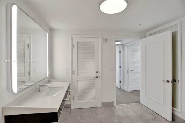 bathroom featuring tile flooring and vanity