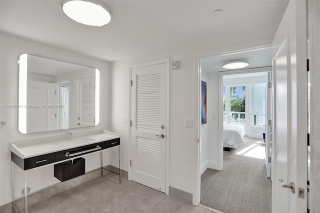 bathroom with vanity with extensive cabinet space and tile flooring