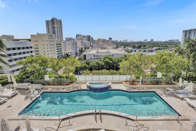 view of pool featuring a patio and a hot tub