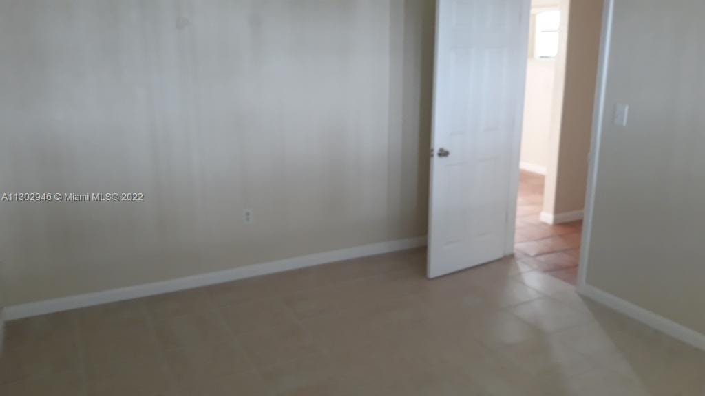 6520 Winfield Blvd Unit 103, Margate, FL 33063 - empty room featuring light tile patterned floors and baseboards