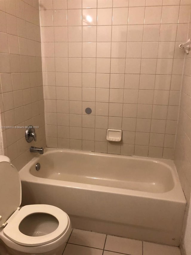 bathroom with toilet and tile floors