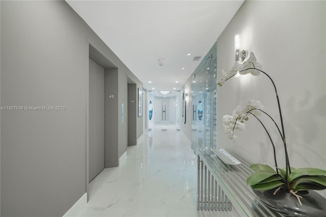 hallway featuring light tile floors and elevator