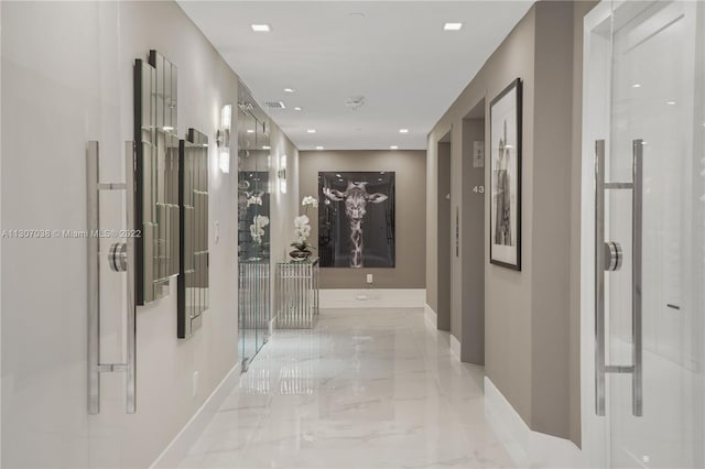 hallway featuring light tile floors