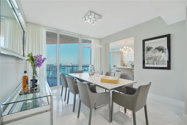 tiled dining space featuring an inviting chandelier and a wall of windows