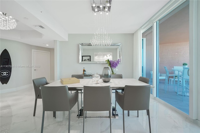 tiled dining area featuring a chandelier