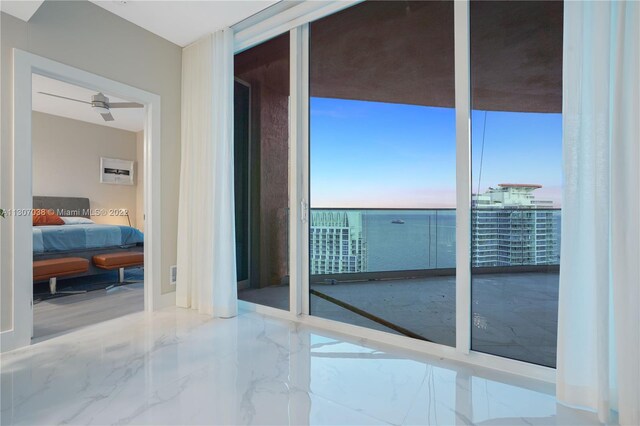 doorway with expansive windows and light tile flooring