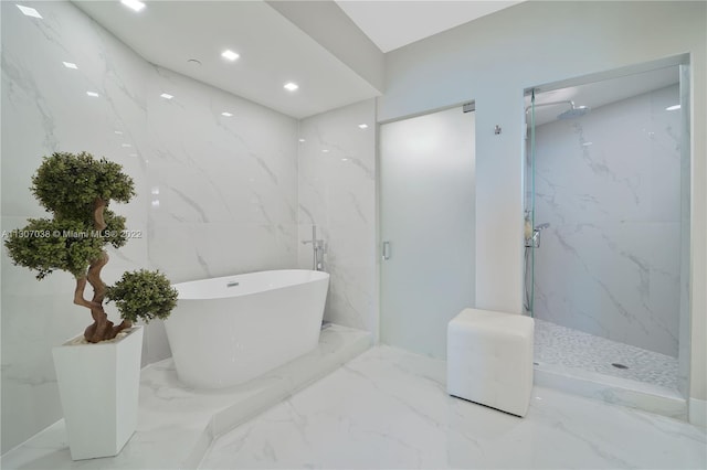 bathroom featuring tile walls, plus walk in shower, and tile flooring