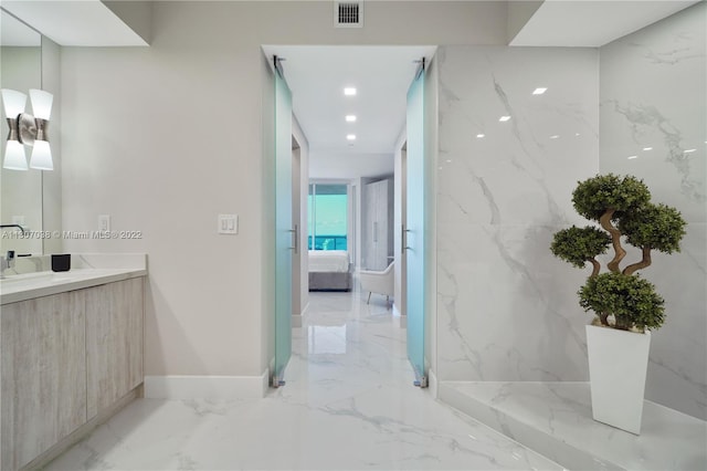 bathroom with tile floors and vanity