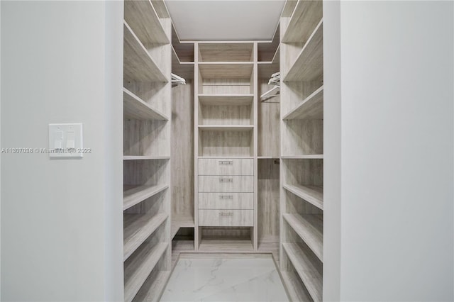 spacious closet featuring light tile floors