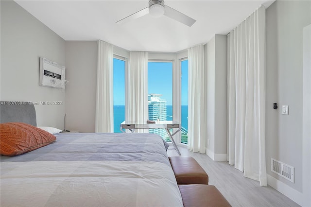 bedroom with light hardwood / wood-style floors and ceiling fan