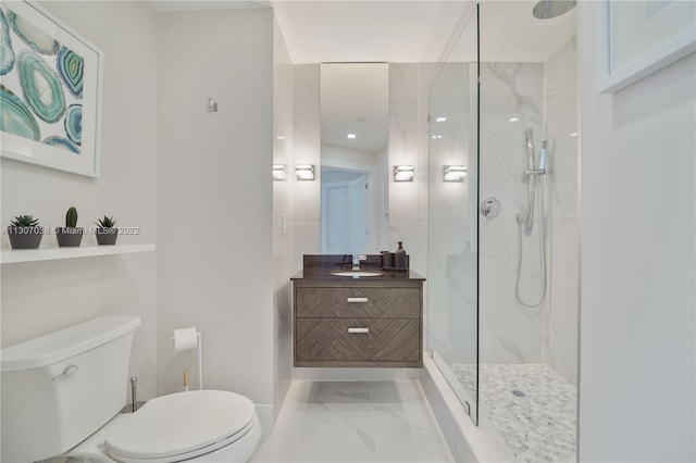 bathroom featuring toilet, a tile shower, large vanity, and tile flooring