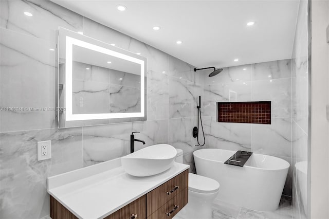 bathroom featuring tile walls, toilet, vanity with extensive cabinet space, and tile flooring