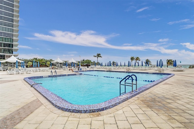 view of swimming pool featuring a patio area