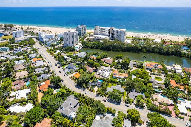 birds eye view of property with a water view and a view of the beach