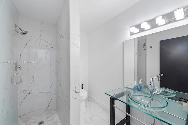 bathroom featuring tile floors, toilet, a tile shower, and vanity