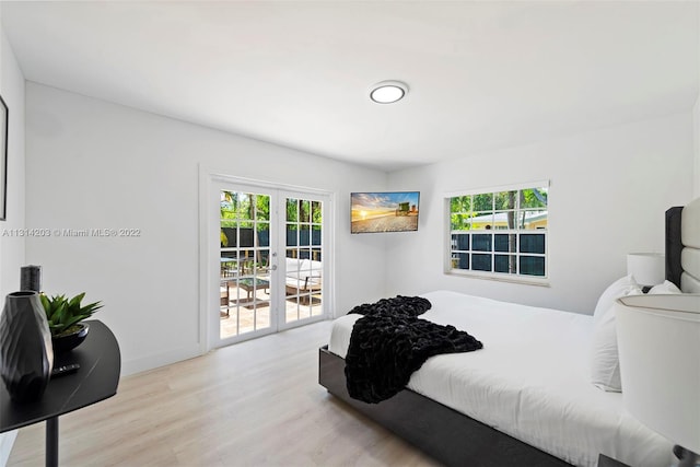 bedroom with access to exterior, french doors, and light wood-type flooring