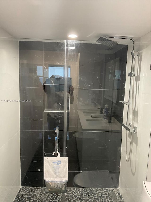 bathroom featuring toilet and an enclosed shower