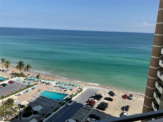 birds eye view of property with a water view and a beach view