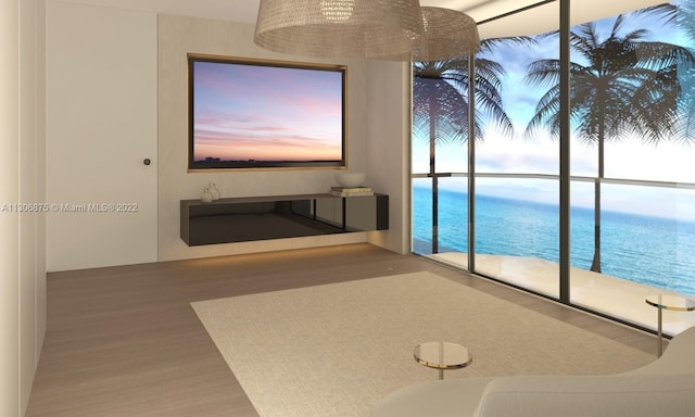 unfurnished living room with a water view and wood-type flooring