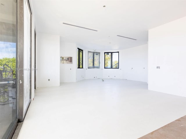 unfurnished room with concrete flooring