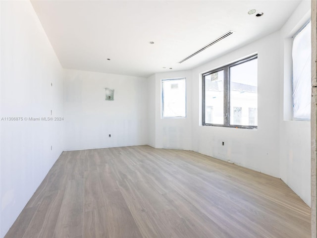 unfurnished room with light hardwood / wood-style flooring