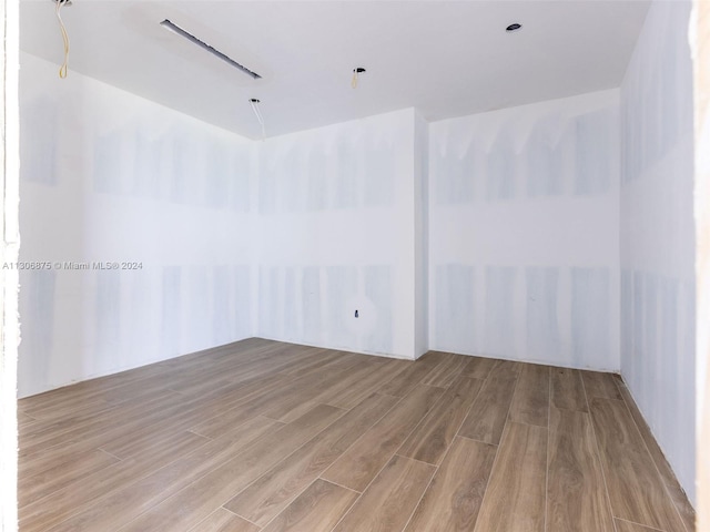 unfurnished room featuring hardwood / wood-style flooring