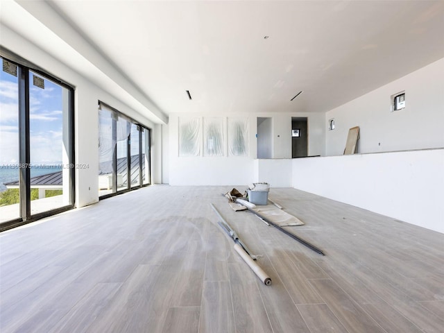 interior space with hardwood / wood-style floors and a water view