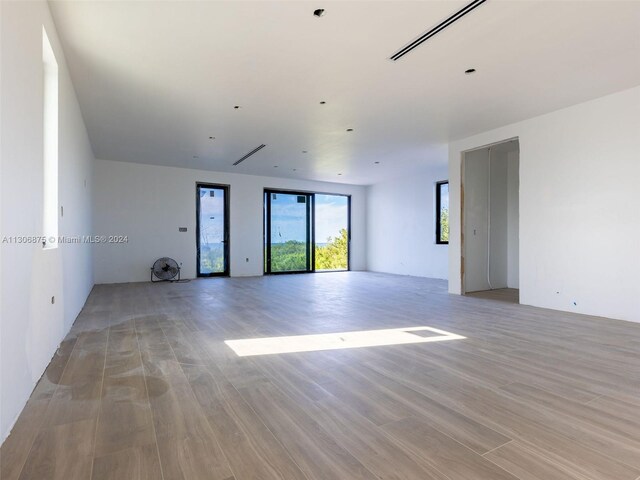 unfurnished room with light hardwood / wood-style floors