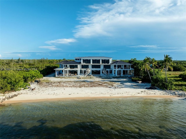 exterior space featuring a view of the beach and a water view