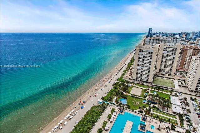 drone / aerial view featuring a water view and a view of the beach