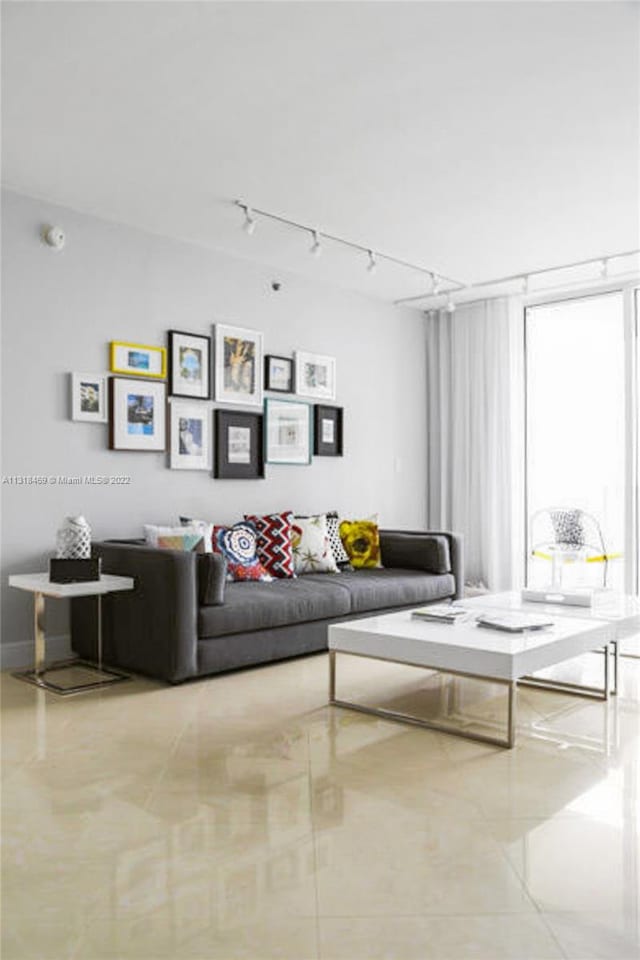 living room with light tile floors and rail lighting