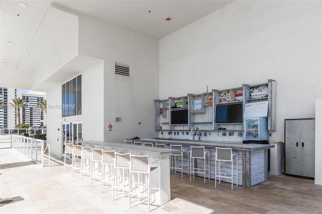 view of patio / terrace with exterior bar and an outdoor kitchen