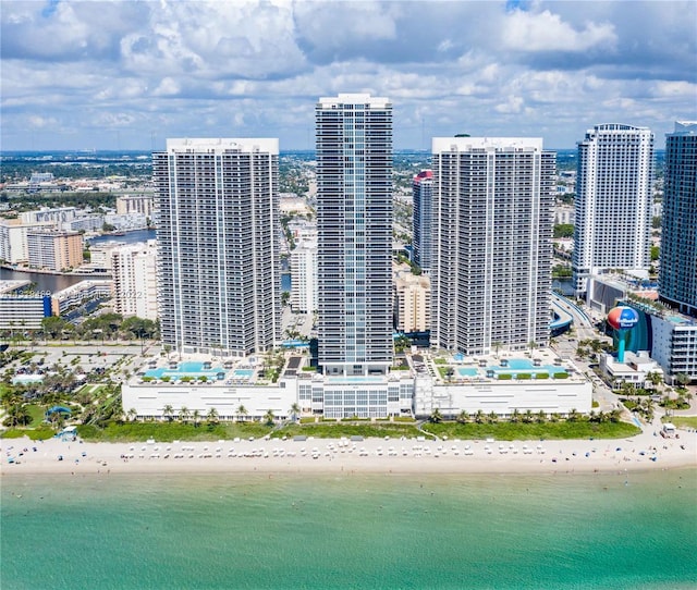 drone / aerial view featuring a beach view and a water view