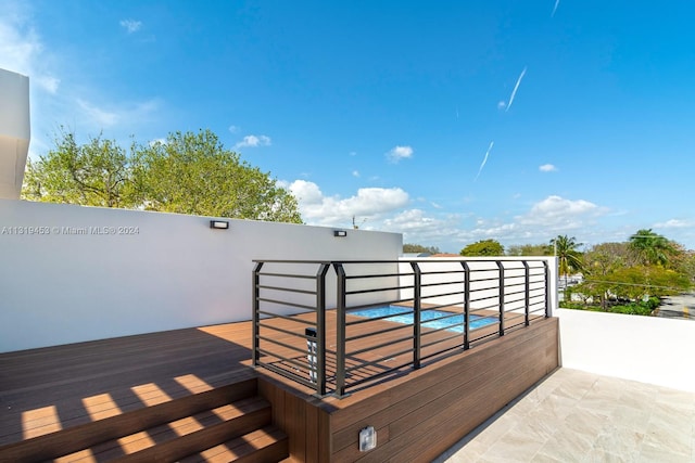 wooden deck featuring a jacuzzi