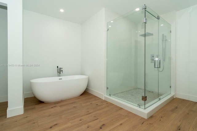 bathroom with wood-type flooring and separate shower and tub