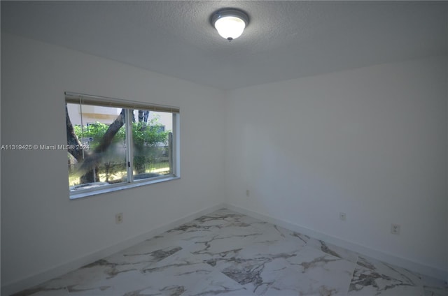 empty room with a textured ceiling